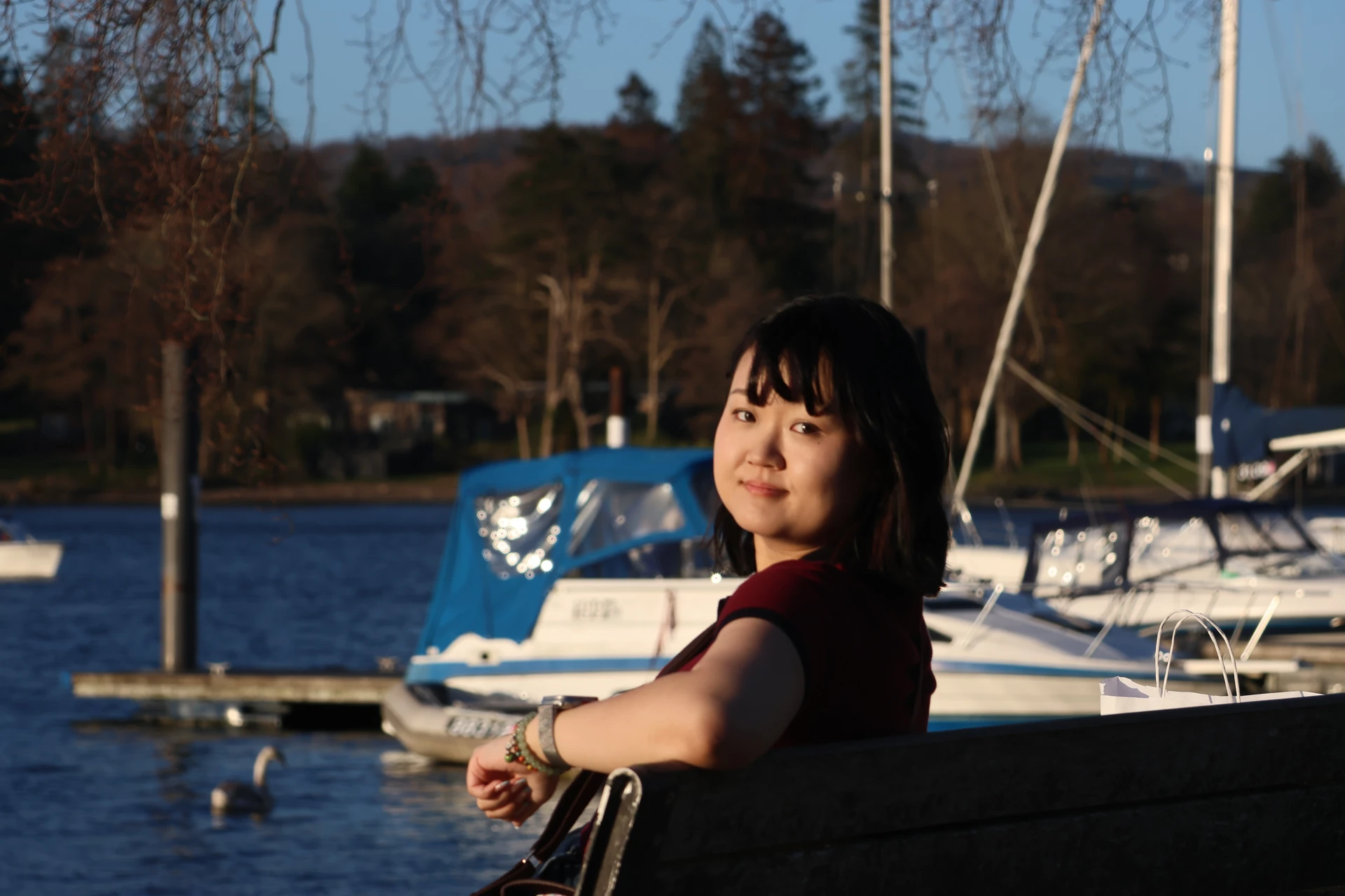 WEI XINRU sitting by the water in evening light